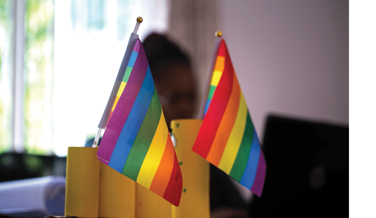 Sarah Chirwa, 30-year-old Head of Admin and Operations at DZL, sits behind her rainbow Pride flags at her desk at the DZL Head Office in Ibex Hill, Lusaka, Zambia on 25 November 2020. Frontline AIDS, in partnership with the Elton John AIDS Foundation, has created a COVID-19 Emergency Fund, which enables healthcare workers from Dignitate Zambia’s (DZL), a Zambia-based community organisation, to offer mobile outreach care support to communities most affected by HIV. The mobile support entails HIV testing, food and grocery supplies, and counselling support for those struggling with the lockdown restrictions as well as survivors of gender-based and domestic violence.