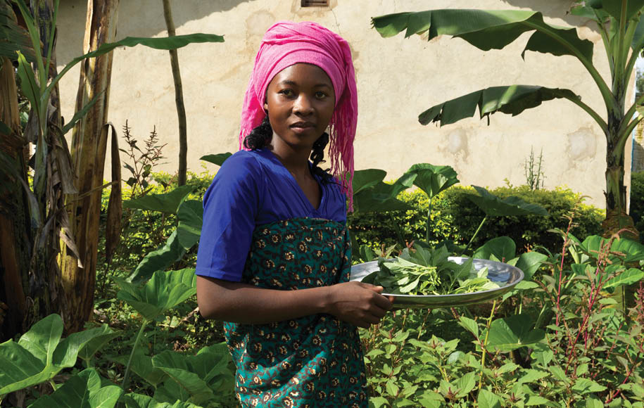 Mother and CATS volunteer Alcanjela Bravius collects her own fresh produce to eat from her garden.