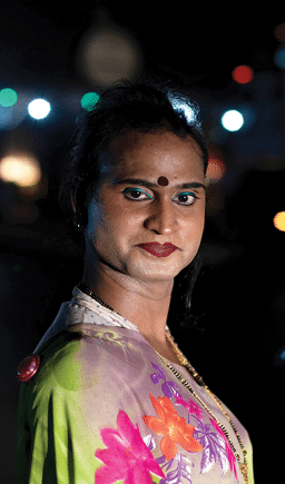 A transgender woman poses for a photograph as she waits for vehicles to stop at a toll plaza on the Ahmedabad – Mumbai highway at midnight on the outskirts of the city of Surat, Gujarat, India, on 25 April 2022. The Accelerating Innovation programme, funded by the Elton John AIDS Foundation, has supported marginalised communities during the COVID-19 pandemic in India.
