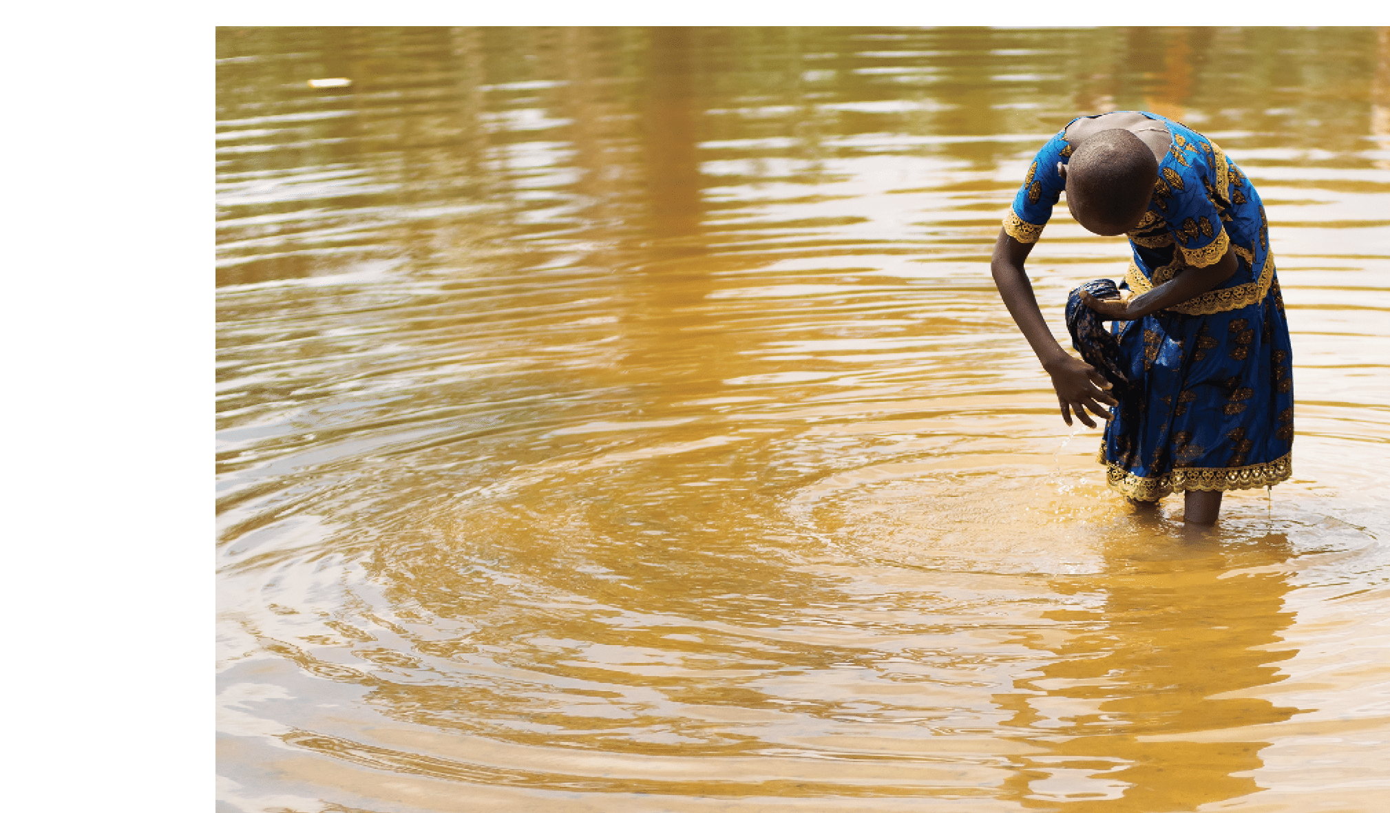 A young girl washes her clothes in a swamp between Soubr and Okrouyo in C te d'Ivoire. This water body might be contaminated with the Schistosoma haematobium parasite, putting the young girl, and others like her, at risk of infection.