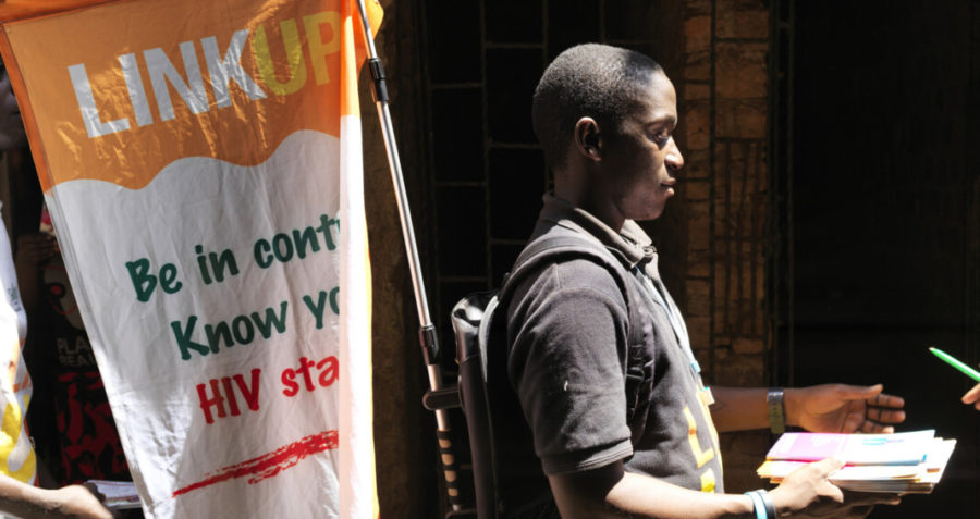 A young man carrying a Link Up sign