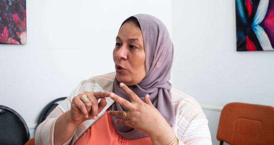 A lady in a headscarf speaking to another person