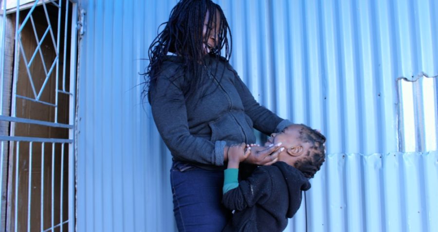 Pamela and her son Phawulothando outside their home