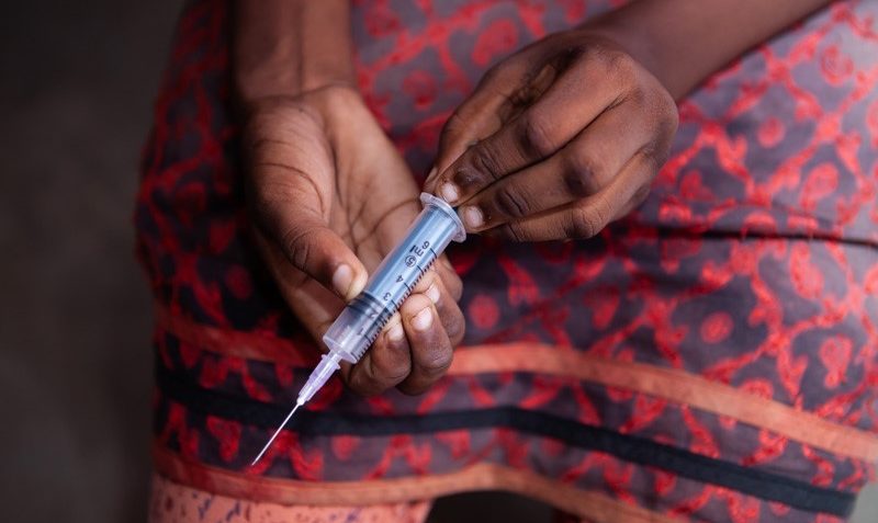 A woman using a syringe