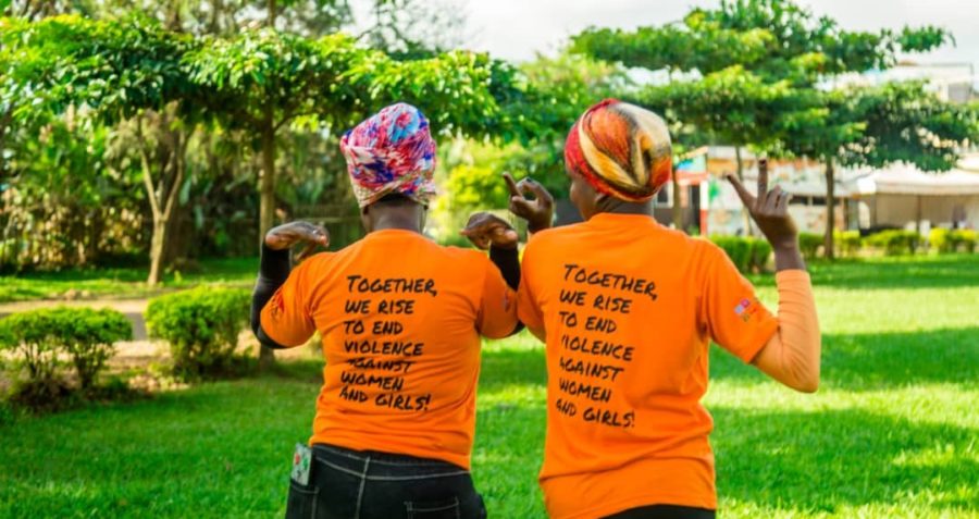 Two women take part in a community event to end gender-based violence