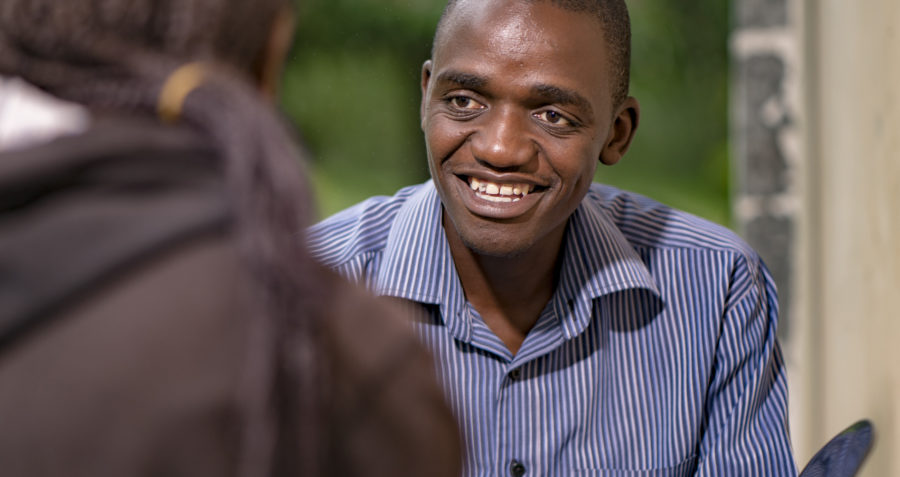 Young man smiling in conversation