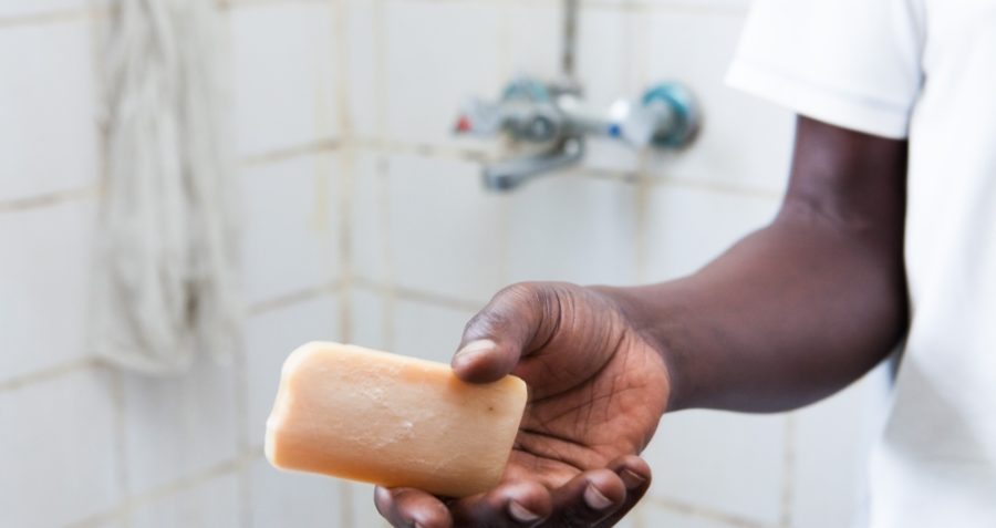 A man holds a bar of soap