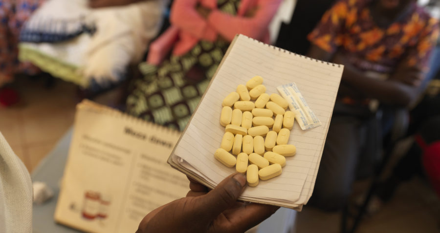 HIV treatment pills resting on a notebook