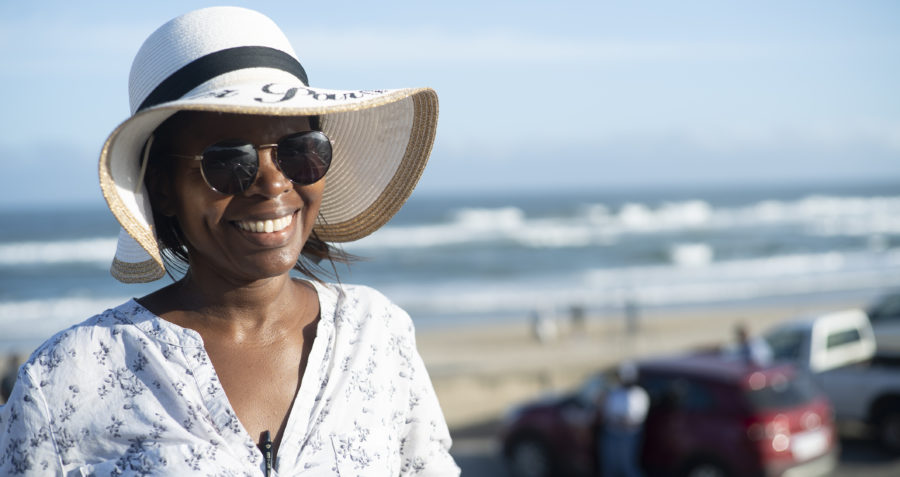 A South African lady wearing a hat at the beach