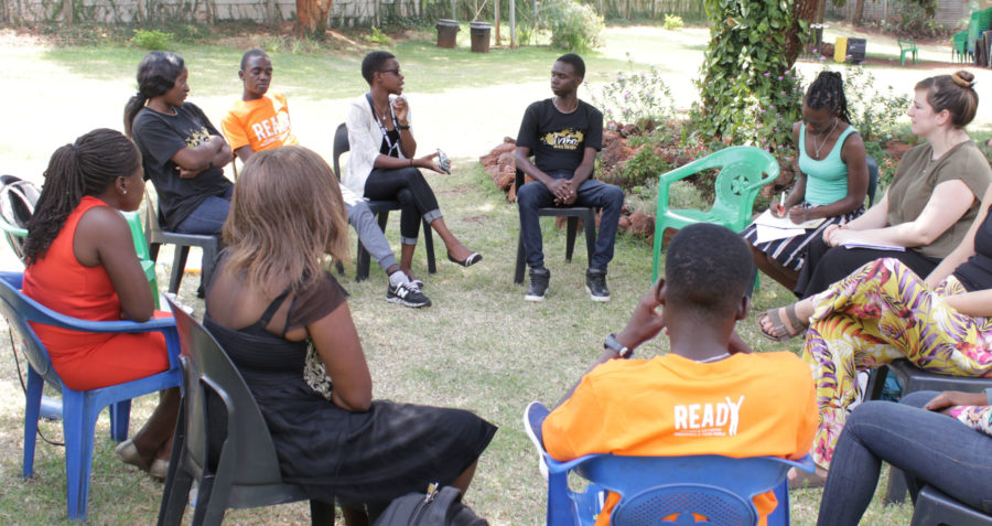 Young people sitting outside in group discussion
