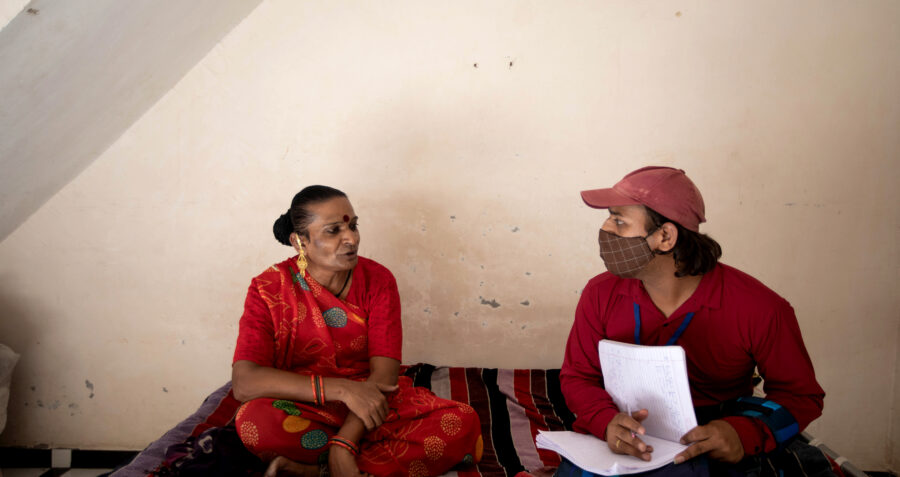 Tulsi, a 41 year old transgender woman, sits and talks with Jayesh, an outreach worker from the Parivartan project