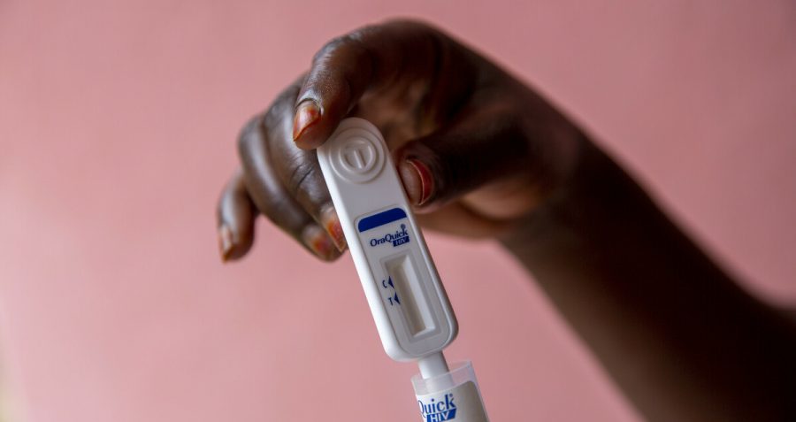 A woman holds an oral HIV test