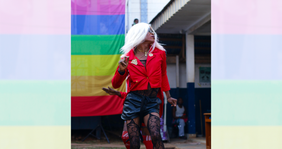 A person wears a red jacket, a short black skirt and suspenders